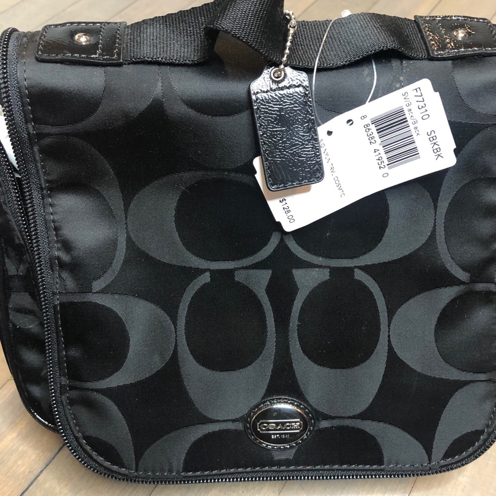 NWT Coach make-up travel bag, black. Zip closure.